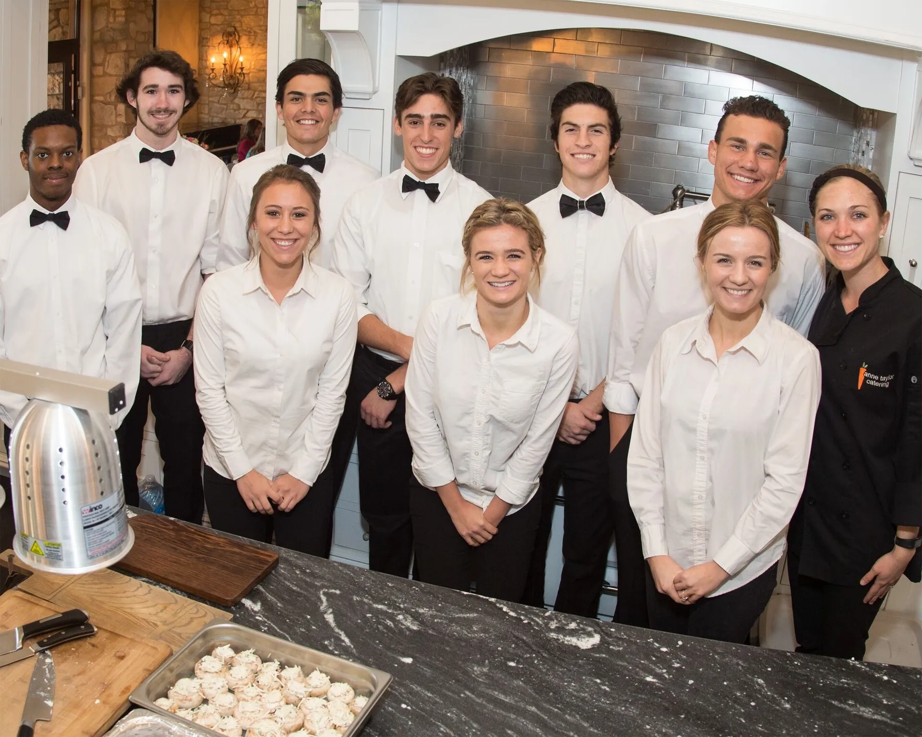Chef Anne Taylor with her catering team of servers in the kitchen